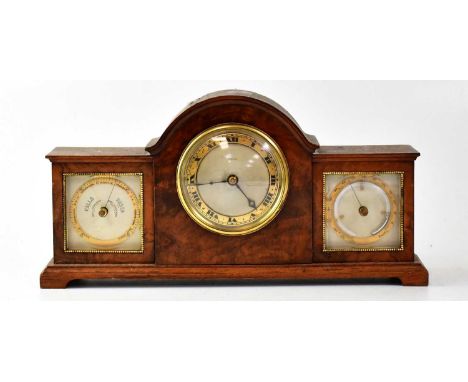 FINNIGANS; a burr walnut desktop combination clock/barometer centred with a silvered dial and gilt brass chapter ring bearing