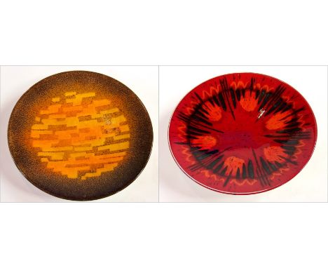 Two Poole plates, one of which is abstract design on a duckshell background, the other is abstract design on a violent red gr