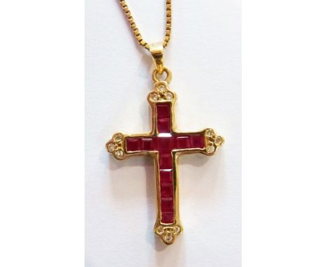14K gold, diamond and ruby crucifix pendant set square cut rubies and having diamond trio cluster terminals and the 14K gold 