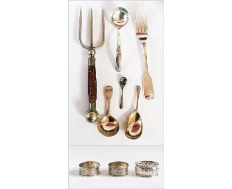 A pair of silver napkin rings and another, three silver caddy spoons, fiddle pattern table fork and a handled silver plated t