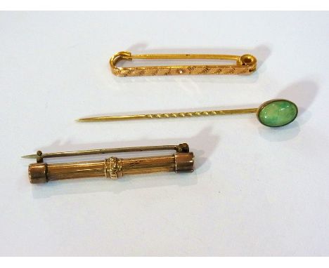 Foreign gold-coloured metal stick pin with polished green stone cabochon cut terminal and two other gold-coloured metal brooc