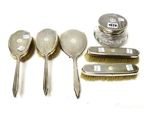 A lady's six piece composite dressing table set, comprising; a lidded faceted glass powder bowl, London 1950, a hand mirror, 