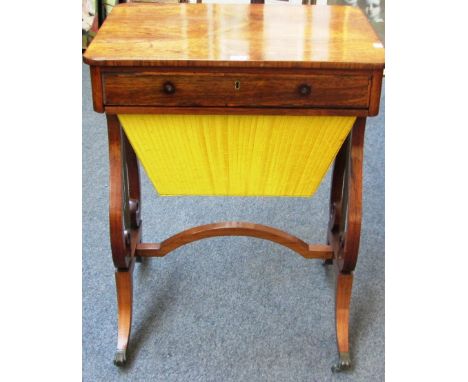 A Regency rosewood single drawer sewing table with pleated silk wool box on lyre supports, 61cm wide.   Illustrated
