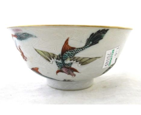 A small Chinese famille-rose bowl, late 19th/early 20th century, painted on the exterior with mythical beasts amongst incised