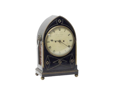 A Regency ebonised mahogany bracket clock by Ross and Peckham, the Gothic style arched case with brass inlaid decoration, cen