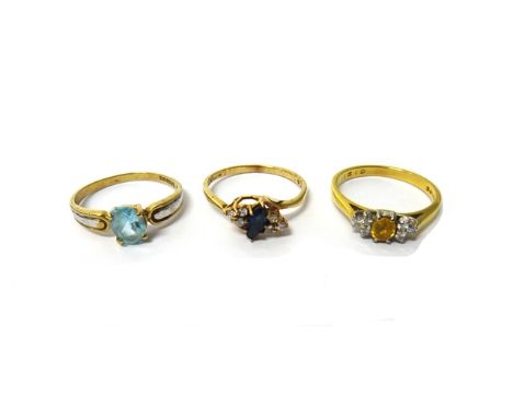 A 9ct gold, sapphire and diamond set ring, in a crossover design, an 18ct gold, diamond and yellow gem set ring and a 9ct gol