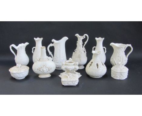 A quantity of parian wares, including; an inkwell of triform shape, a bottleneck vase relief moulded with portrait masks, 18.