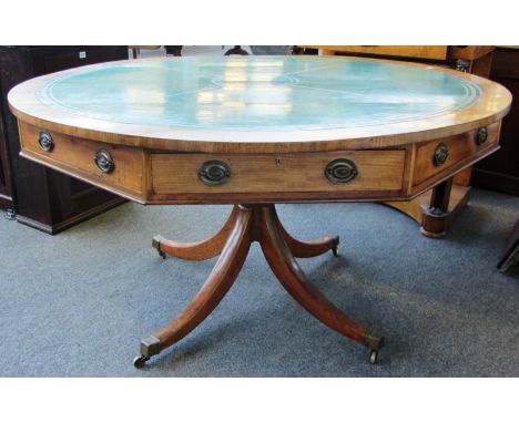 A George III design mahogany drum table, the circular top over a four drawer octagonal frieze on four downswept supports, 137