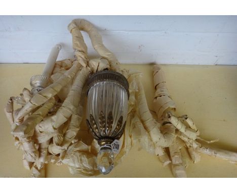 A Victorian cut glass and ormolu mounted three branch wall light with foliate cast oval backplate issuing three light sconces