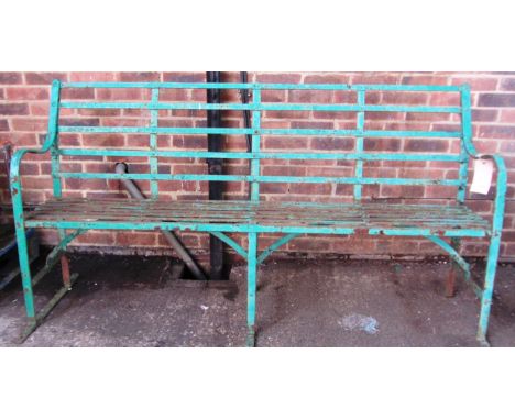 An early 20th century green painted wrought iron slatted garden bench, 183cm wide. 