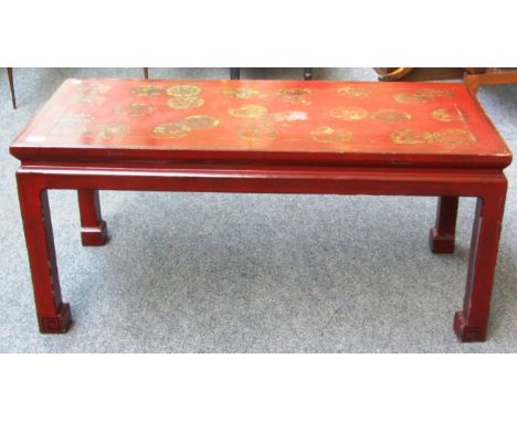 A early 20th century red lacquer gilt decorated rectangular coffee table on block supports, 93cm wide. 