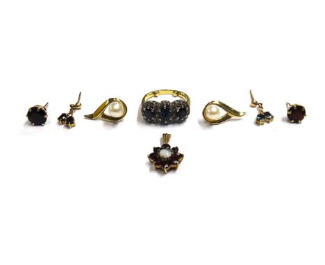 An 18ct gold, sapphire and diamond set triple cluster ring, claw set with three oval cut sapphires, with diamond set surround