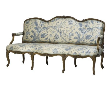 A Louis XV walnut framed open arm sofa with serpentine seat on cabriole supports, 180cm wide.  Illustrated
