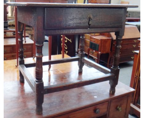 A 17th century oak single drawer side table on turned supports with perimeter stretcher, 75cm wide.