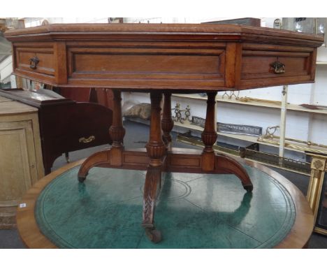 A Victorian oak octagonal drum/centre table, the rotating top on four downswept supports, 122cm wide. 