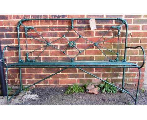 A green painted wrought iron garden bench, 135cm wide. 