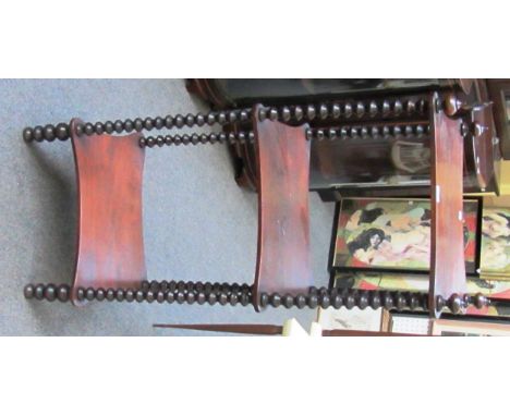 A 19th century rosewood three tier whatnot on bobbin turned supports, 44cm wide.