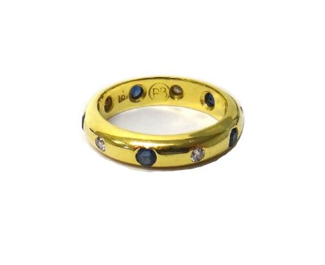 A gold, sapphire and diamond set full eternity ring, gypsy set with cushion shaped sapphires, alternating with smaller circul