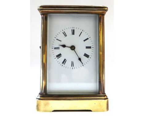 A brass cased carriage clock, early 20th century, with swing over handle, white enamel dial and two train movement, 12.5cm hi