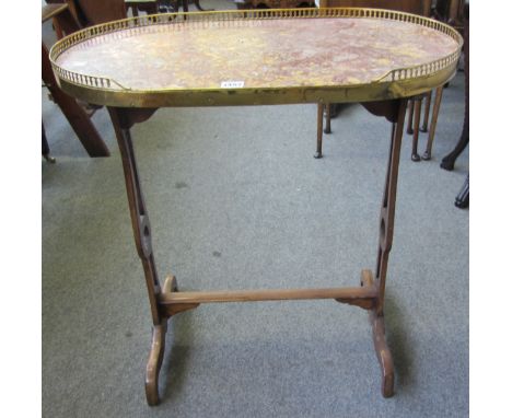 A 19th century French gilt metal mounted marble top oval occasional table on trestle end standards, 68cm wide. 