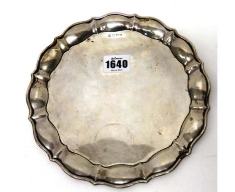 A silver shaped circular waiter, with a Chippendale style piecrust rim, the hallmark rubbed, diameter 20.3 cms, weight 238 gm
