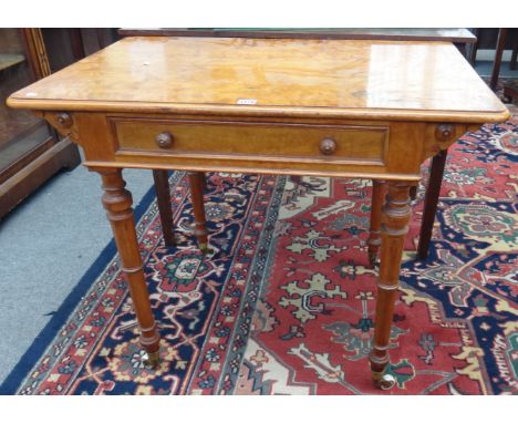 A Victorian satinwood writing table with pop up stationery compartment over single frieze drawer stamped John Taylor & Sons E