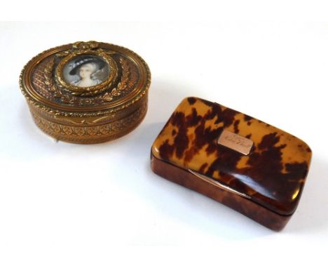 An oval gilt metal snuff box, 19th century, the lid inset with a painted miniature of a lady, relief cast with bows and laure