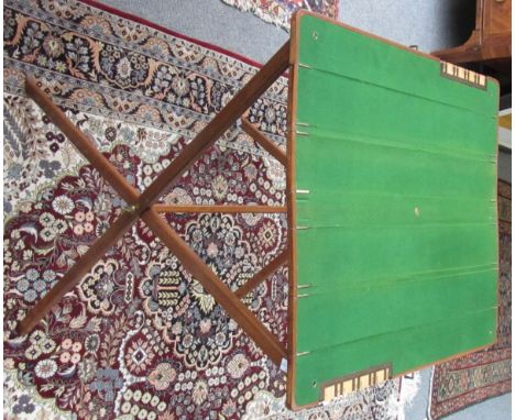 An early 20th century folding/travelling bridge table with integral scorers on an 'X' frame base, 61cm x 60cm. 