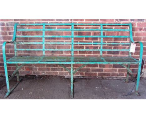 An early 20th century green painted wrought iron slatted garden bench, 183cm wide. 