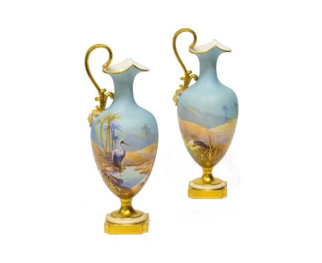 A pair of Royal Worcester ewers by Albert Shuck, circa 1913 ,each of ovoid form with gilded scroll handle and mask terminal, 