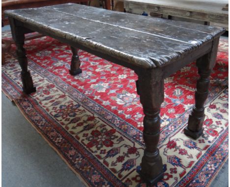 A 17th century and later oak double plank top table on turned supports, 166cm long x 67cm wide. 