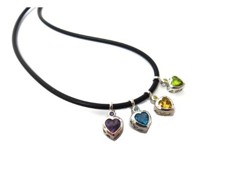 A white gold and coloured gemstone set necklace, mounted with a row of four vary coloured heart shaped pendants, comprising; 