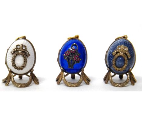 A Russian rose diamond and white enameled egg shaped pendant locket, a Russian rose diamond and coloured gem set and blue ena