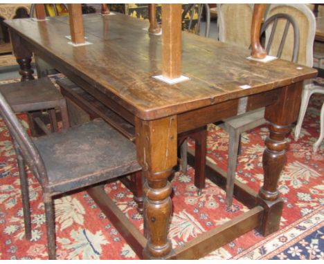 A 17th century style oak plank top refectory table on baluster turned supports, 73cm wide x 174cm long. 