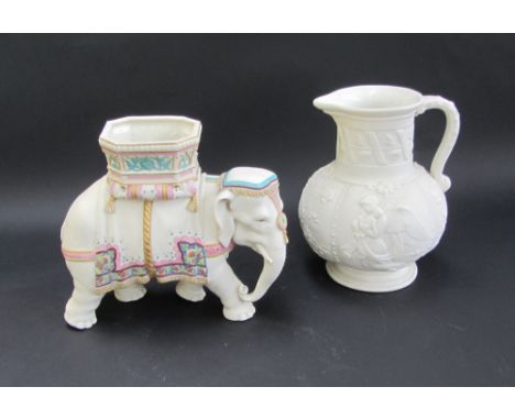 A Royal Worcester parian elephant modelled by James Hadley, wearing a howdah over a tasselled cover and gilt embelishments, 1