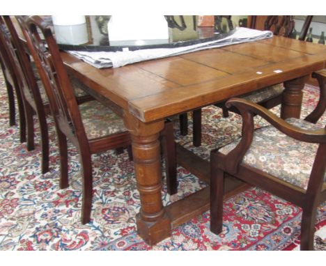 A large 17th century design plank top refectory table on turned supports, 121cm x 243cm.