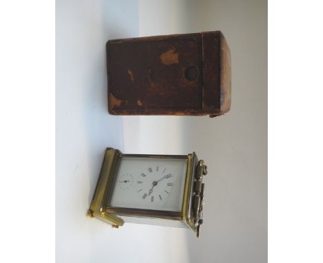 A French gilt cased carriage clock, early 20th century, with white enamel dial, subsidiary alarm dial and two train movement,