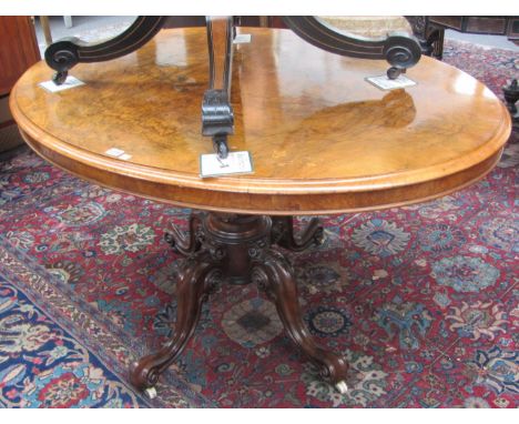 A Victorian inlaid figured walnut oval loo table on four downswept supports, 130cm x 98cm.