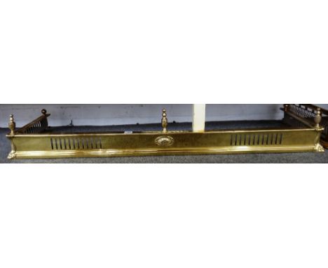 A Victorian brass fire fender with pierced frieze (156cm wide), a brass Adams style fire fender with three urn finials (130cm