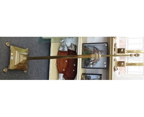 A modern brass telescopic standard lamp of Corinthian column form, on a stepped graduated square base and four lions paw feet