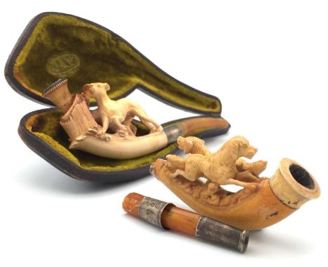 A Meerschaum pipe, 19th century, carved with a whippet in a landscape, length 14.5cm, cased, together with another depicting 