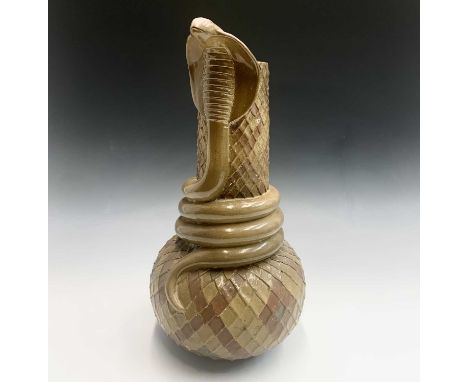 A glazed terracotta vase, snake scale effect with applied coiled cobra decoration to neck. Height 57.5cm.