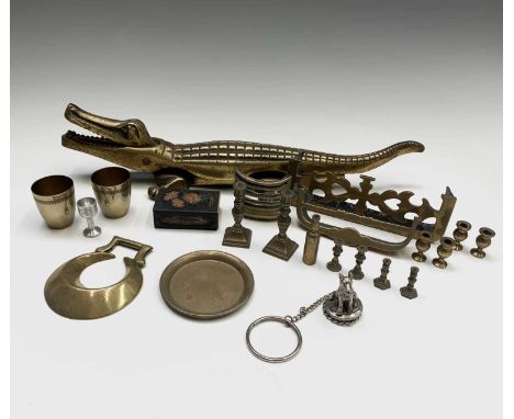 A brass crocodile nutcracker, length 38cm, together with two miniature fenders and other items.