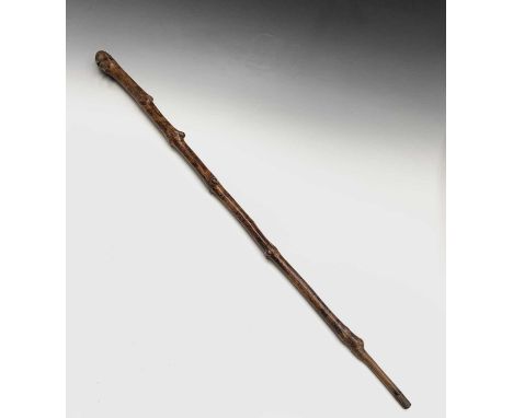 An unusual early 19th century naive walking stick, the terminal carved as a bearded man wearing a patterned cap and with inse