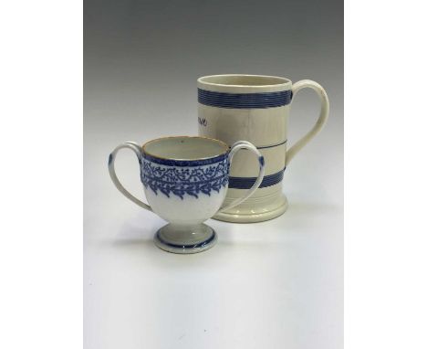 A large pearlware engine turned tankard, circa 1820, with blue painted bands and named H. Rouse, together with a blue printed