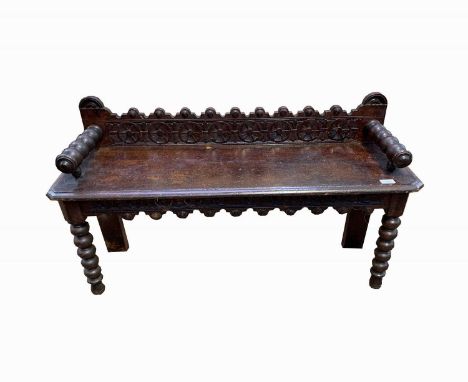 A Victorian oak hall bench, with bobbin turned arms and legs, height 61cm, width 107cm, depth 32.5cm.
