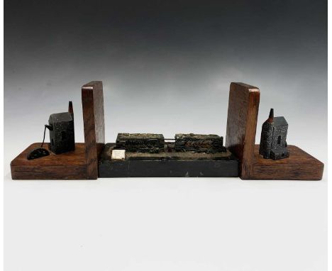 A pair of oak bookends, mid 20th century, each mounted a model of a Cornish engine house, height 14cm, together with a model 