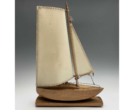 A 1930s table lamp, modelled as a yacht, the sail forming the shade, height 56cm.