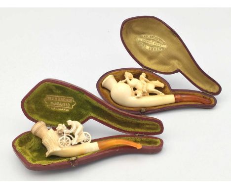A Meerschaum pipe, 19th century, carved with a horse and rider, length 11cm, cased, together with another, carved with a figu