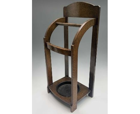 An Art Deco period oak stick stand, bearing ivorine label to reverse 'Homettes Reg.d'. Height 67.5cm, width 30cm, depth 21cm.